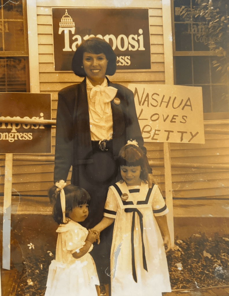 Maggie Goodlander in front of Nashua Loves Betty sign and Tamposi sign